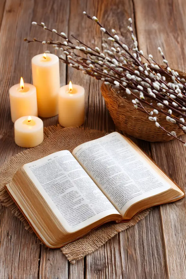 open bible with candle and old books